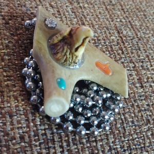 Hand carved deer antler pendant